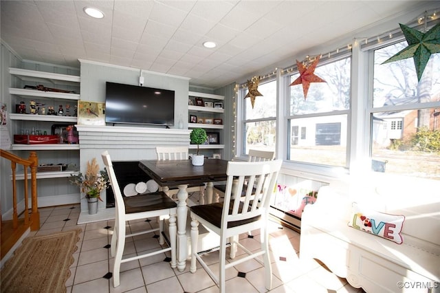 interior space featuring light tile patterned floors and a baseboard heating unit