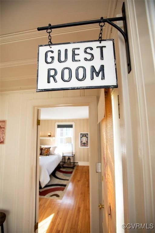 hallway with wooden walls and hardwood / wood-style flooring