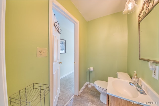 bathroom with tile patterned flooring, vanity, and toilet