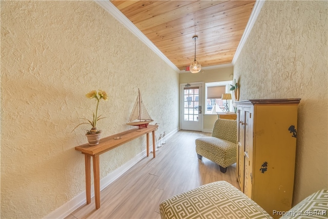 sitting room with wooden ceiling, ornamental molding, and hardwood / wood-style flooring