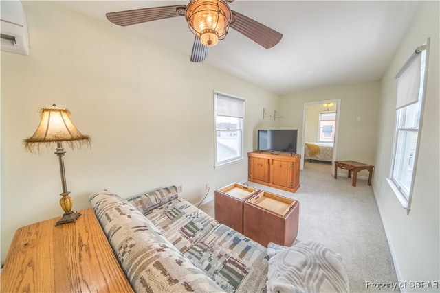 carpeted living room with ceiling fan