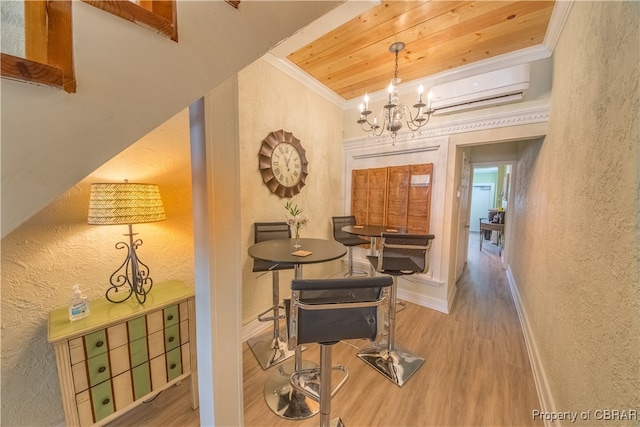 hall with hardwood / wood-style flooring, an AC wall unit, crown molding, and a notable chandelier