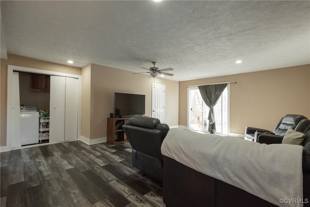 living room featuring a textured ceiling, ceiling fan, washer / dryer, and dark wood-type flooring