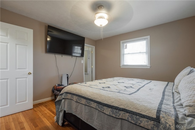 bedroom with ceiling fan and hardwood / wood-style floors