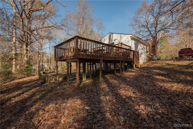 rear view of house with a wooden deck