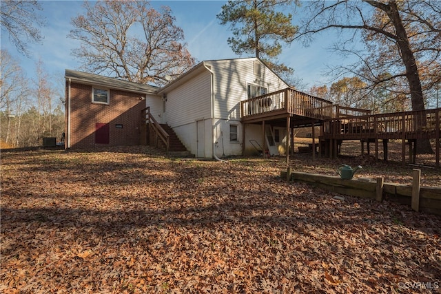 back of house featuring cooling unit and a deck