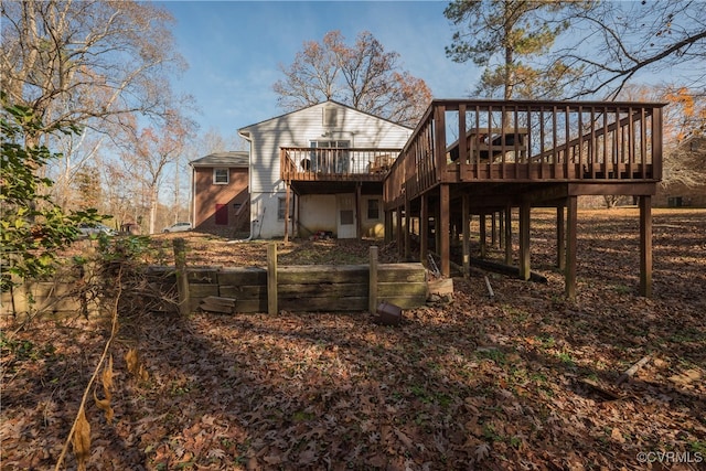 rear view of property featuring a wooden deck