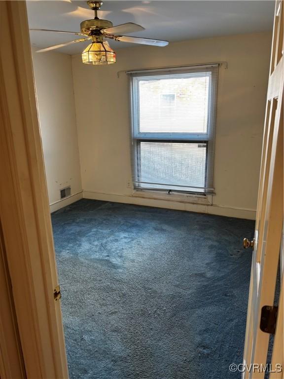 carpeted empty room with ceiling fan