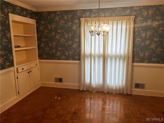 unfurnished dining area featuring dark parquet floors, an inviting chandelier, a healthy amount of sunlight, and ornamental molding