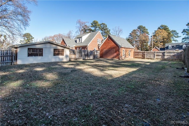 rear view of house featuring a yard