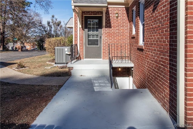 property entrance featuring central AC unit