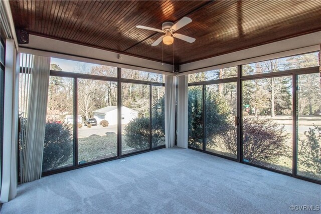 unfurnished sunroom featuring ceiling fan and wooden ceiling