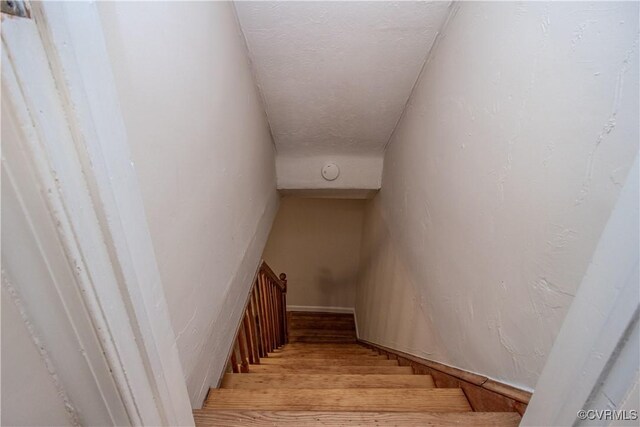 staircase featuring wood-type flooring