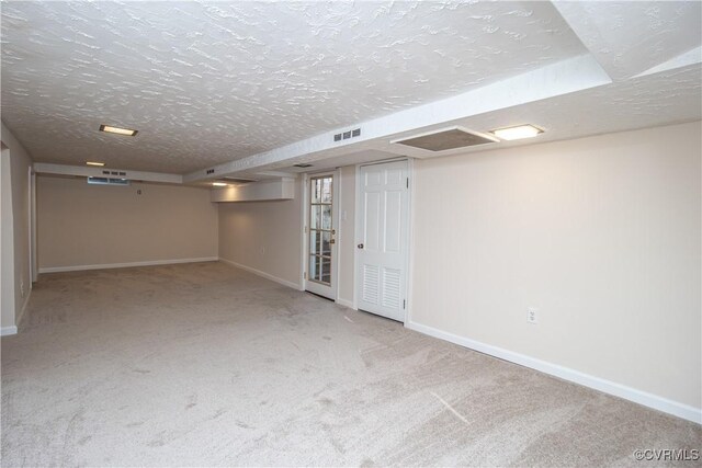 basement with carpet floors and a textured ceiling