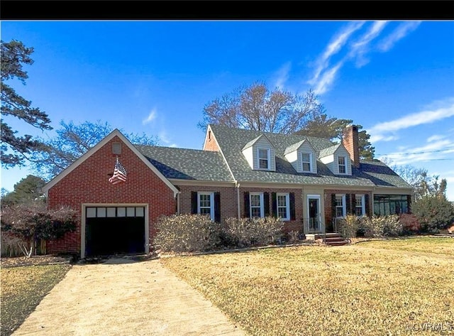 new england style home featuring a front yard and a garage