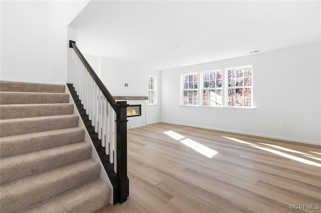 stairs with hardwood / wood-style floors