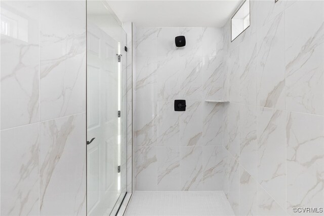 bathroom with a tile shower