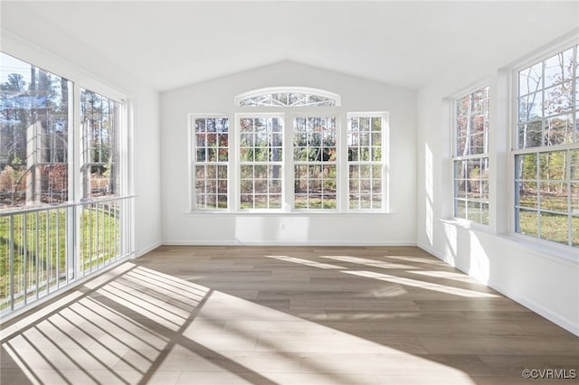 unfurnished sunroom featuring vaulted ceiling