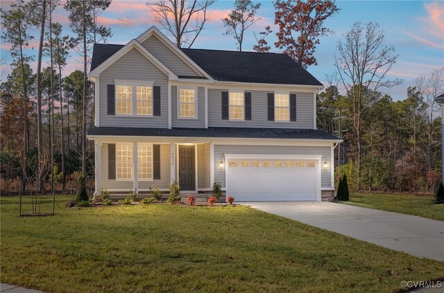 view of front of house featuring a lawn and a garage