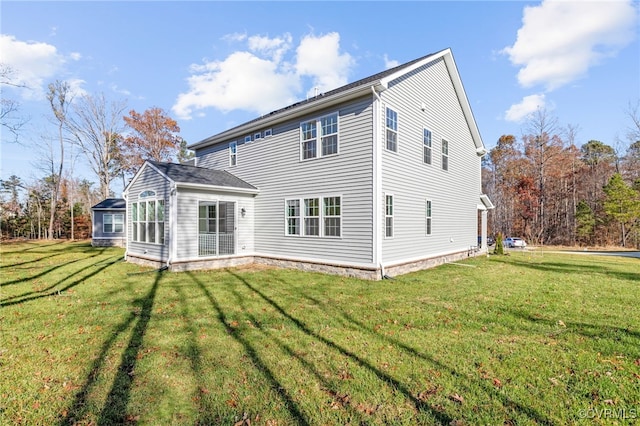 rear view of house featuring a yard