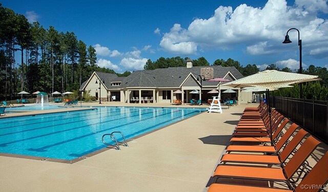 view of swimming pool with pool water feature