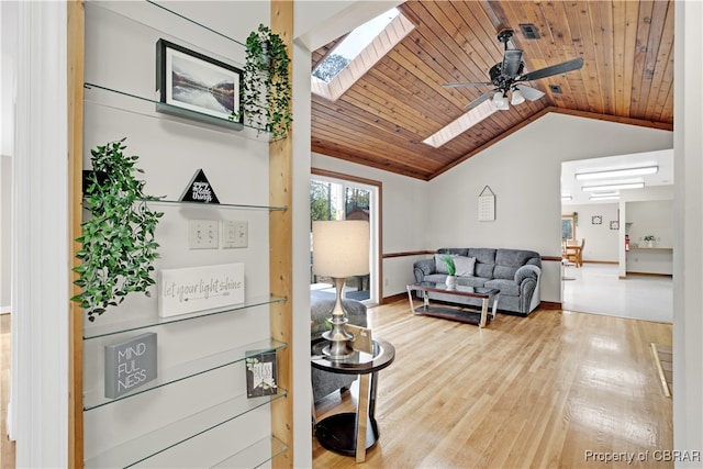 living room featuring hardwood / wood-style flooring, ceiling fan, wooden ceiling, and vaulted ceiling with skylight