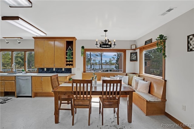 dining room with plenty of natural light, sink, and a chandelier