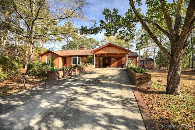 ranch-style home featuring a carport