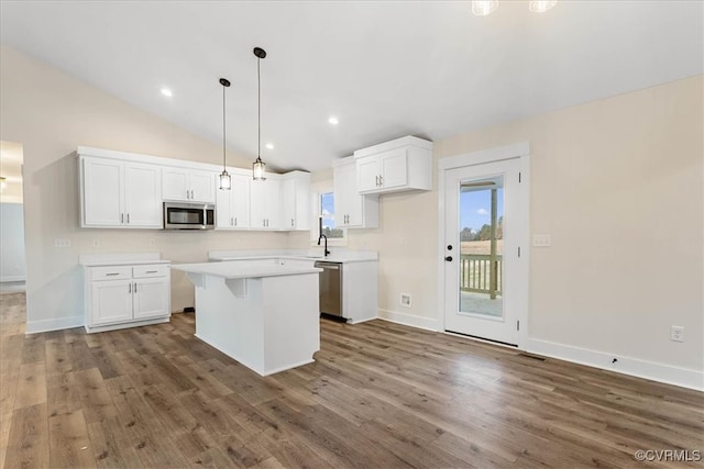 kitchen featuring white cabinetry, pendant lighting, a kitchen island, and stainless steel appliances