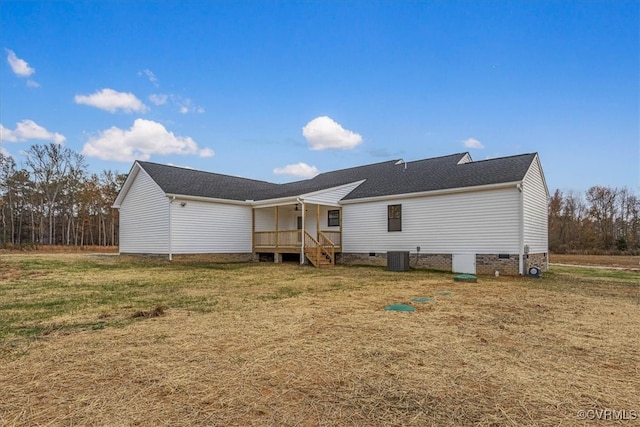 rear view of property with a yard and central AC unit