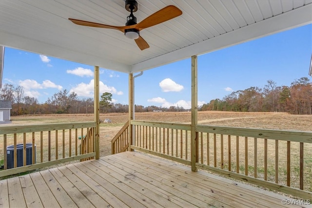 wooden deck with central air condition unit, ceiling fan, and a rural view