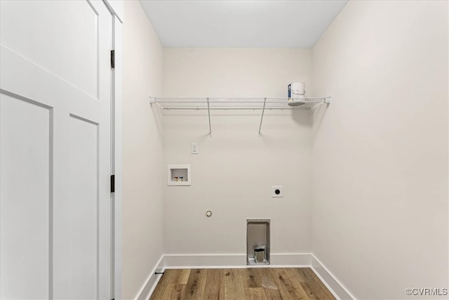 clothes washing area with electric dryer hookup, hookup for a gas dryer, light wood-type flooring, and hookup for a washing machine