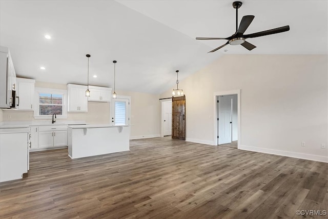 kitchen featuring ceiling fan, a center island, white cabinets, and dark hardwood / wood-style floors