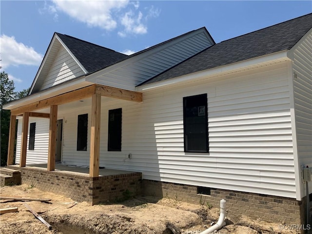 14310 Meadow Ln, Disputanta, VA 23842 - view of side of home with a shingled roof, covered porch, and crawl space