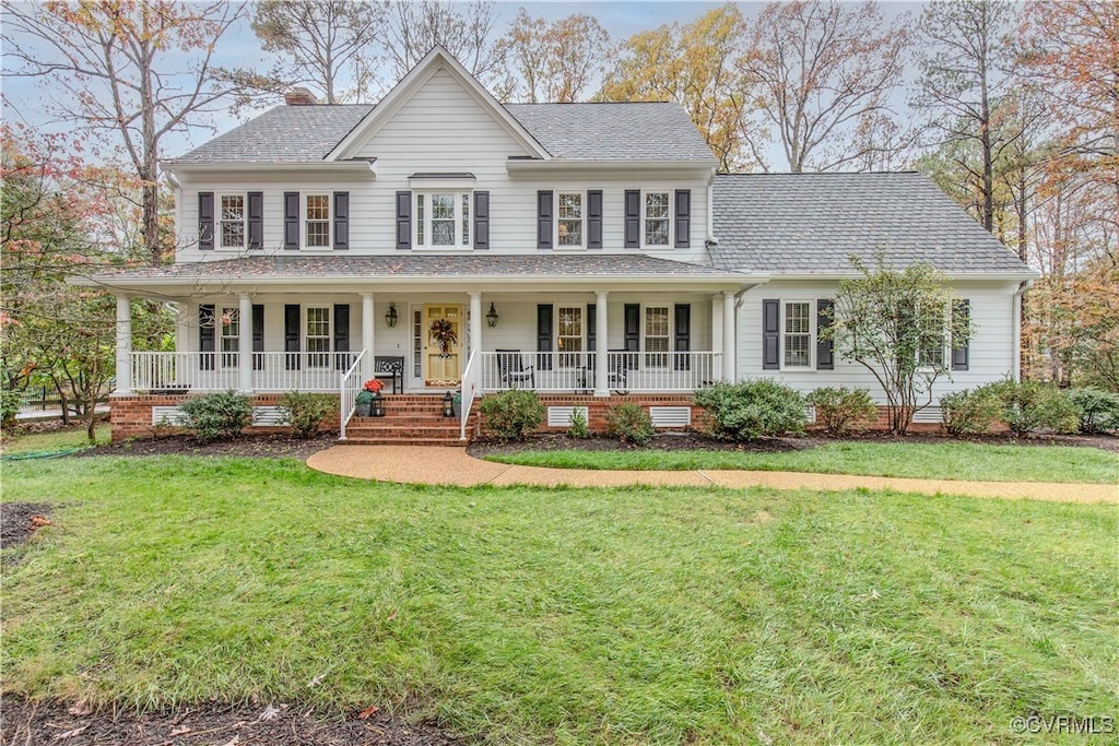 view of front of house featuring a front yard and a porch