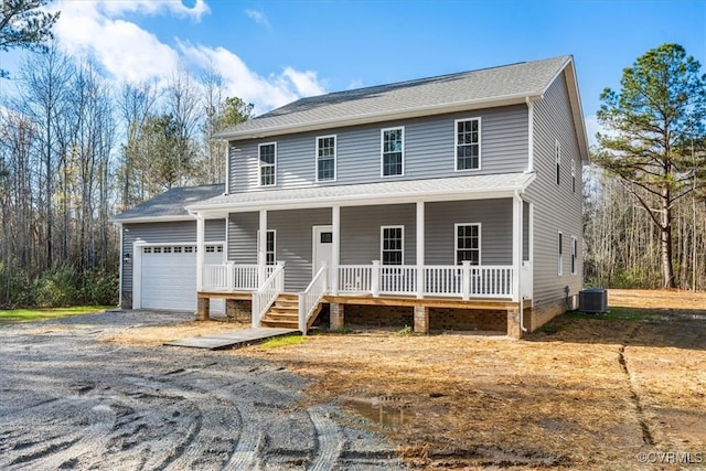 view of front of property featuring cooling unit, a porch, and a garage