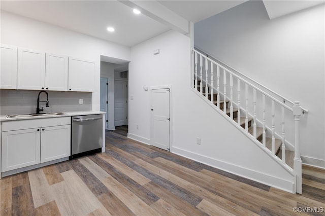 kitchen featuring dishwasher, white cabinets, light wood-type flooring, and sink