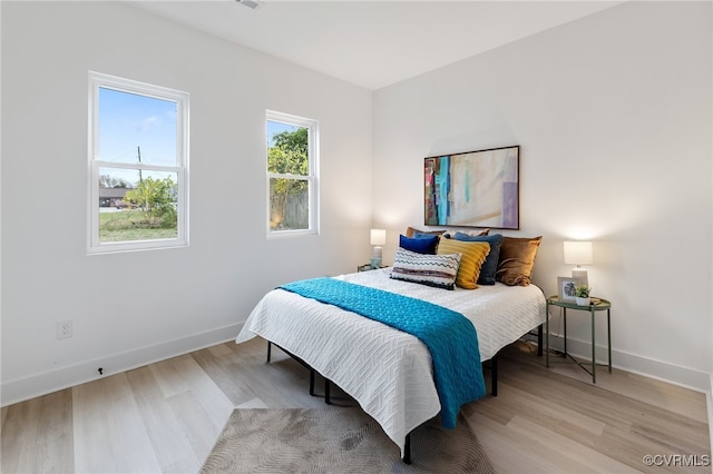 bedroom with light wood-type flooring