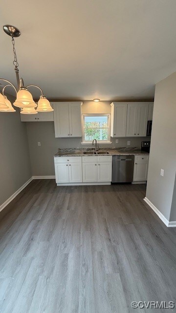 kitchen with dishwasher, wood-type flooring, white cabinets, and sink