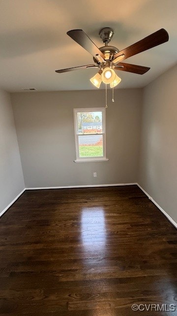 empty room featuring ceiling fan and dark hardwood / wood-style floors