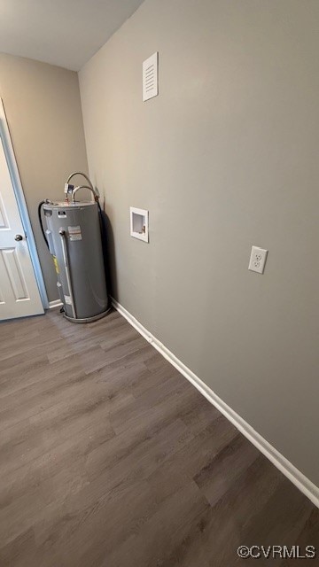 clothes washing area with hardwood / wood-style floors, hookup for a washing machine, and water heater