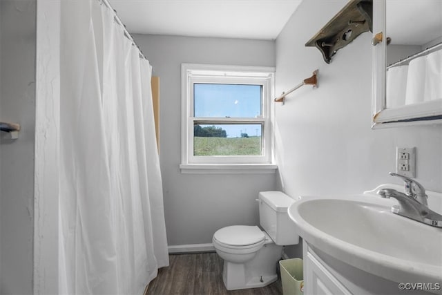 bathroom with hardwood / wood-style floors, vanity, and toilet