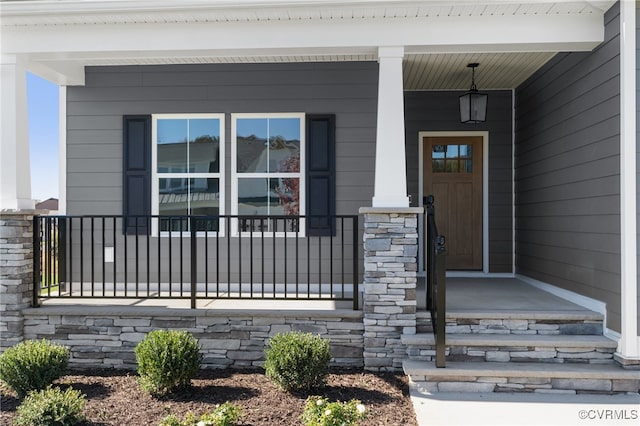 view of exterior entry with a porch