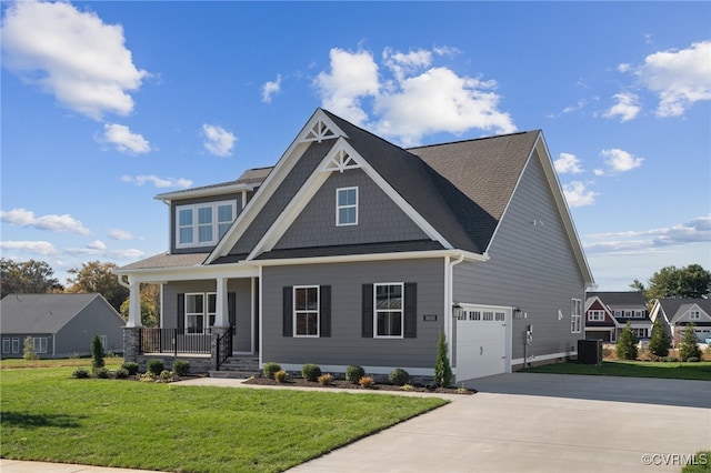 craftsman inspired home with a porch, central AC unit, a garage, and a front lawn