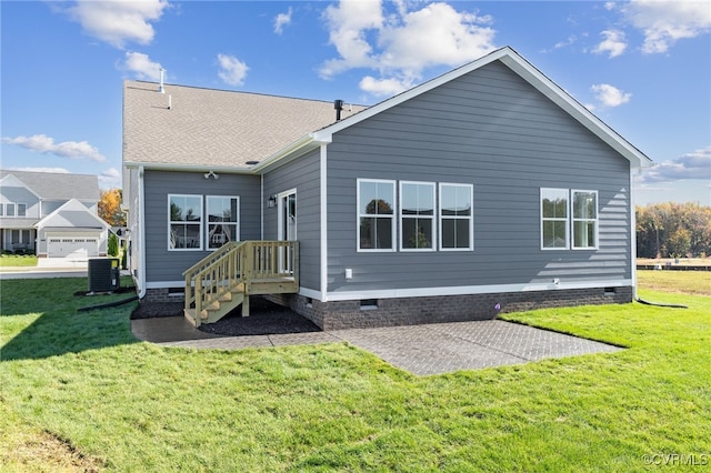 back of property featuring a yard and central AC unit