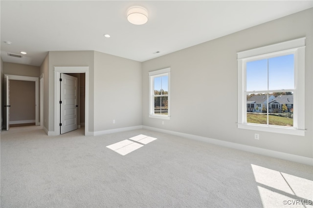 carpeted empty room with a healthy amount of sunlight