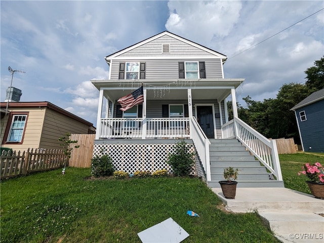 view of front of house with a front yard and a porch