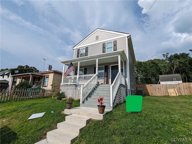 view of front of house featuring covered porch and a front lawn