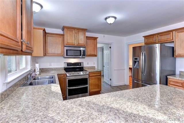 kitchen featuring stainless steel appliances, dark hardwood / wood-style floors, and sink