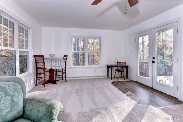 living area featuring carpet flooring, ceiling fan, and french doors